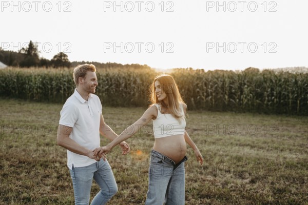 Pregnant, young woman with partner