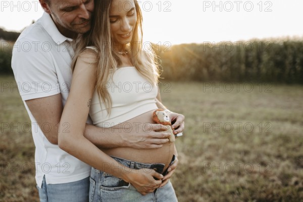 Pregnant, young woman with partner
