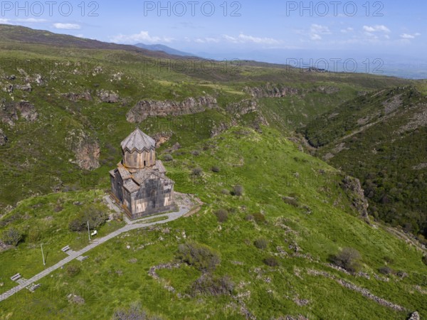 Small church on a green mountain overlooking a valley, aerial view, Church of the Mother of God,