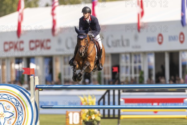 Ben Maher of England, riding Enjeu De Grisien, competes in the first round of the 2025 BMO Nations