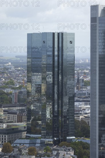 The surroundings of Frankfurt city centre are reflected on the glass façade of the Deutsche Bank