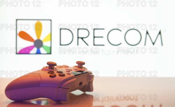 Dhaka, Bangladesh- 13 Sep 2025: A close-up of a white gamepad with the Drecom seen on screen in the