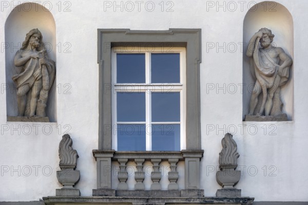 West façade with window and two stone figures, New Castle in Kisslegg, Allgäu, Baden-Württemberg,