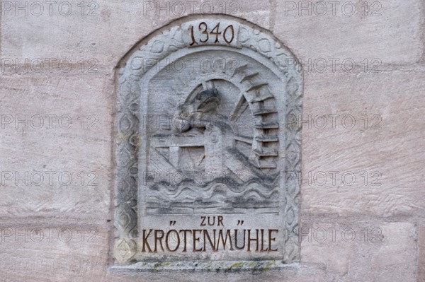 Relief of the former toad mill from 1340 on a house wall on the Pegnitz, Karlsbrücke, Nuremberg