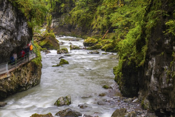 Breitach flows through a narrow gorge with stones, stream, Schrattenkalk, visitors on footbridge,