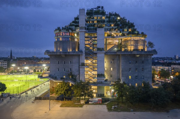 Aerial view of the Hamburg bunker on Heiligengeistfeld during the blue hour with illuminated floors