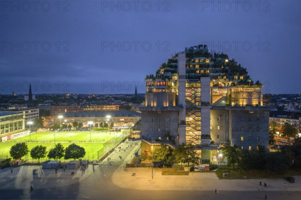 Aerial view of the Hamburg bunker on Heiligengeistfeld during the blue hour with illuminated floors