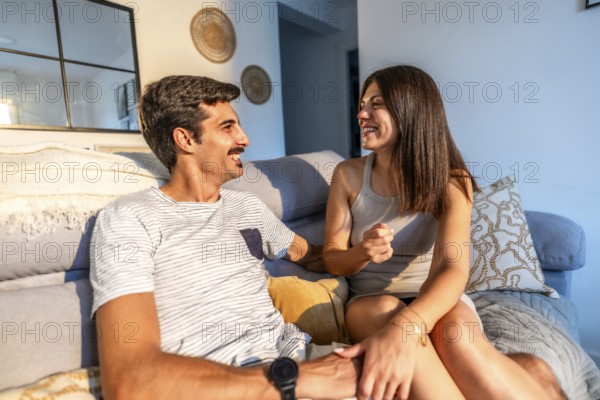 Young couple enjoying a relaxing afternoon together, sharing stories and laughter on their