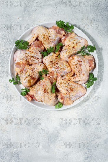 Marinated chicken wings prepared for grilling with spices and fresh herbs ready for cooking