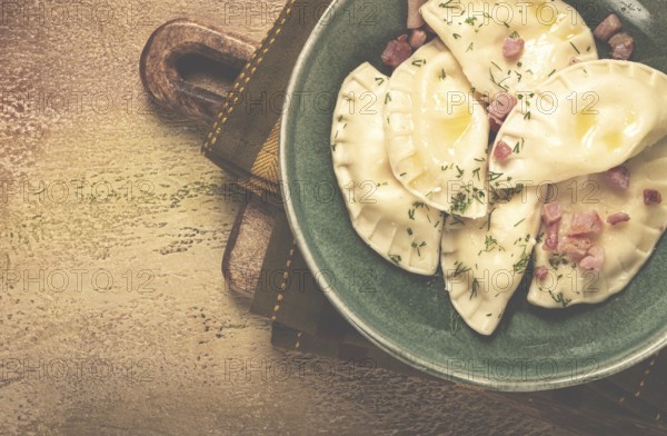Dumplings, with fried prosciutto, a traditional dish of Polish cuisine, dumplings, top view,