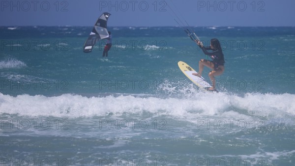 Kitesurfer dynamically jumping over a wave on the open sea, Prasonisi, beach, surf, windsurfer,