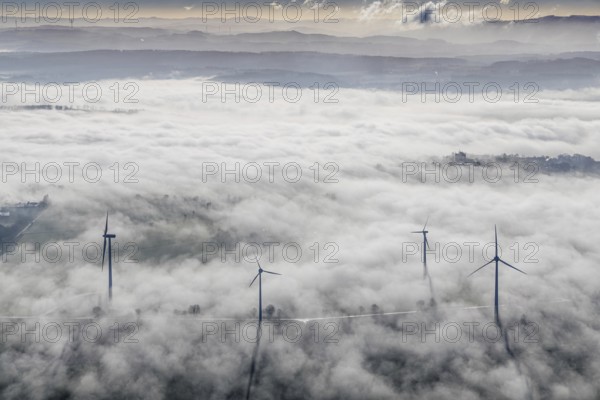 Aerial view, wind turbines in the fog and mountains of the Sauerland in the backlight in the