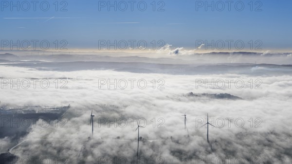 Aerial view, wind turbines in the fog and mountains of the Sauerland in the backlight in the