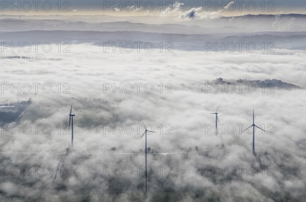 Aerial view, wind turbines in the fog and mountains of the Sauerland in the backlight in the