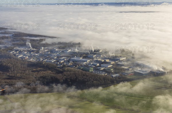 Aerial view, industrial area Westerhaar in fog and mountains of the Sauerland in backlight in