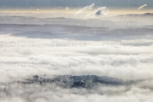 Aerial view, residential area in fog with high-rise building, mobile phone antennas in backlight in