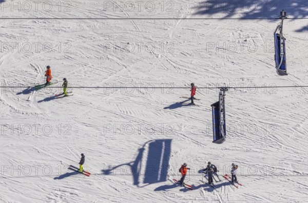 Skiers on ski slope and chairlift, Winterberg, Sauerland, North Rhine-Westphalia, Germany, DE,