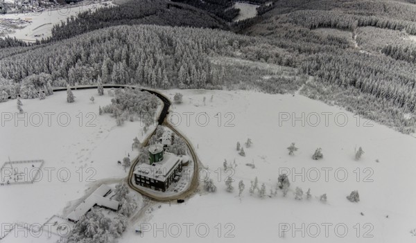Aerial view of the snowy winter landscape of Winterberg am Kahlen Asten with Astenturm during