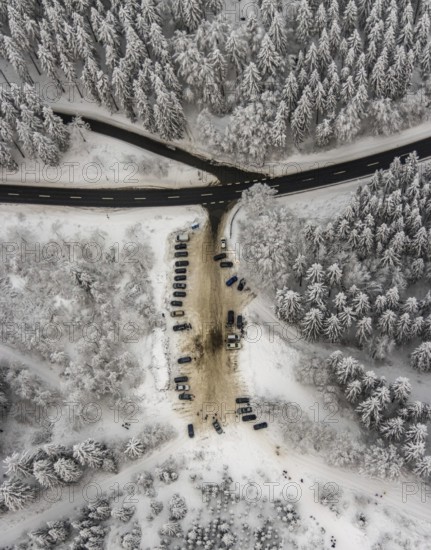 Aerial view of the snowy winter landscape of Winterberg with car park Helleplatz at Kahlen Asten in