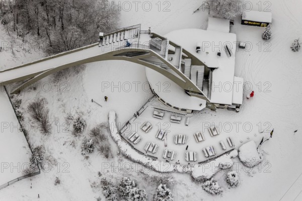 Aerial view of the snowy winter landscape of Winterberg with the St. Georg ski jump in the