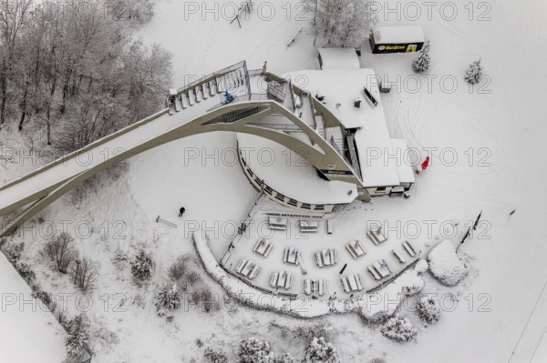 Aerial view of the snowy winter landscape of Winterberg with the St. Georg ski jump in the
