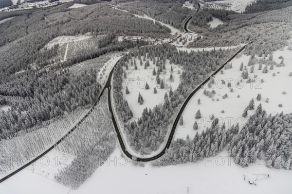 Aerial view of the snowy winter landscape of Winterberg with winding roads and paths in the