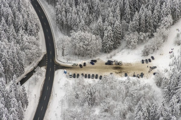 Aerial view of the snowy winter landscape of Winterberg with car park Helleplatz at Kahlen Asten in