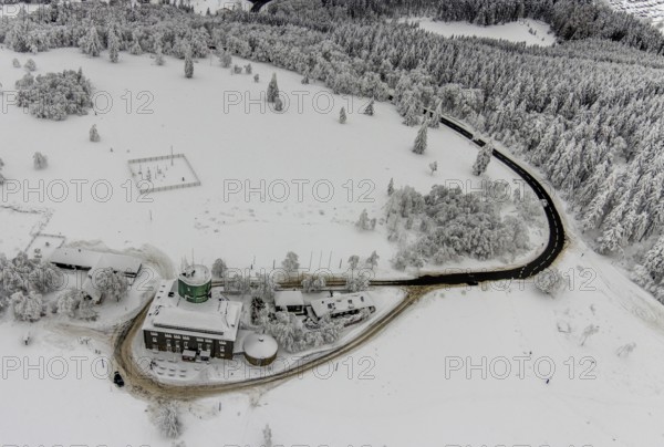 Aerial view of the snowy winter landscape of Winterberg am Kahlen Asten with Astenturm during