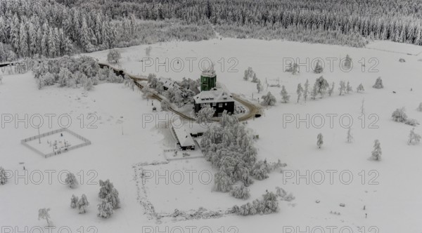 Aerial view of the snowy winter landscape of Winterberg am Kahlen Asten with Astenturm during