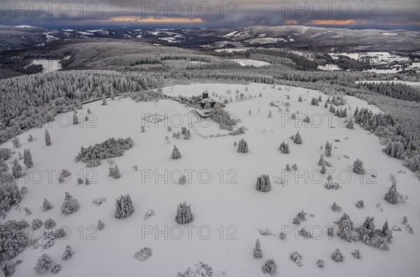 Aerial view of the snowy winter landscape of Winterberg am Kahlen Asten with Astenturm during
