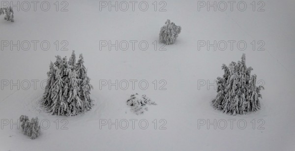Aerial view of the snowy winter landscape of Winterberg below the Kahler Asten with snow-covered