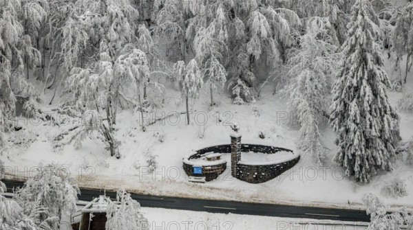 Aerial view of the snowy winter landscape of Winterberg below the Kahler Asten with snow-covered
