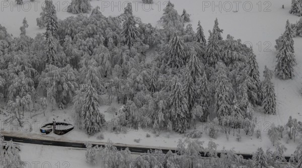 Aerial view of the snowy winter landscape of Winterberg below the Kahler Asten with snow-covered