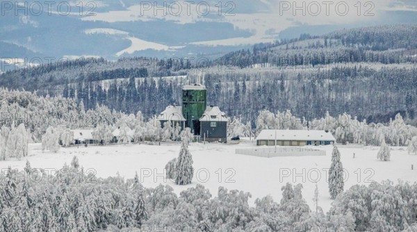 Aerial view of the snowy winter landscape of Winterberg am Kahlen Asten with Astenturm during