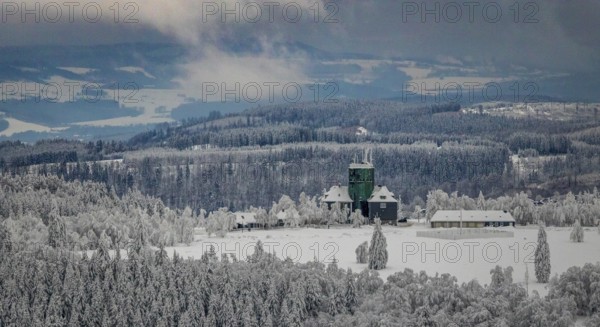 Aerial view of the snowy winter landscape of Winterberg am Kahlen Asten with Astenturm in times of