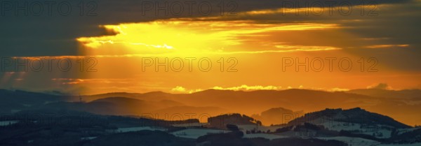 Aerial view of the sunset with a view over the snowy winter landscape from Winterberg to the