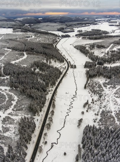 Aerial view of the Ruhr valley with the meandering Ruhr as a stream in the snowy winter landscape