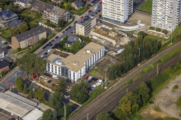 Aerial view, high-rise housing estate and construction site with new building for a retirement home