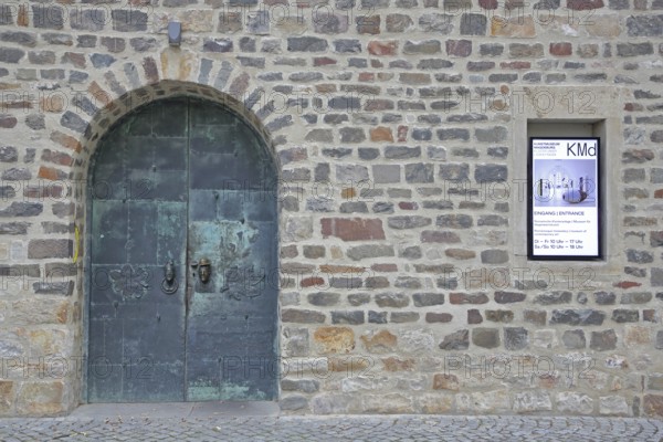 Door and entrance to the art museum, metal door, banner, stone wall, art museum, Kloster Unser