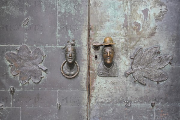 Door by Heinrich Apel 1974 at the entrance to the museum, bronze sculptures two faces, man, woman,