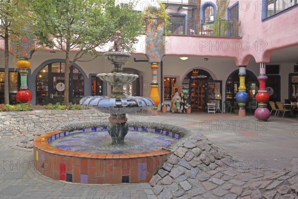 Inner courtyard with fountain and colourful columns, Green Citadel, Hundertwasser House, Magdeburg,