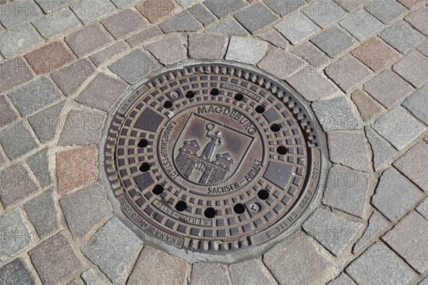 Manhole cover with city coat of arms, paving stones, floor, inscription, Magdeburg, Saxony-Anhalt,