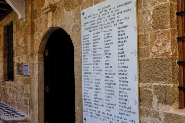 Memorial plaque with names on an old stone wall in a town, Kahal Shalom Synagogue, Sephardic