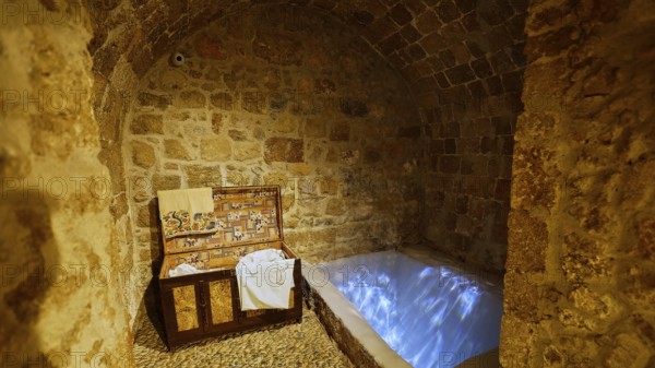 A stone room with an illuminated immersion bath for ritual purification, Kahal Shalom Synagogue,
