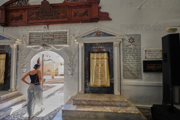 A woman enters a synagogue through a decorative arch, Kahal Shalom Synagogue, Sephardic Synagogue,