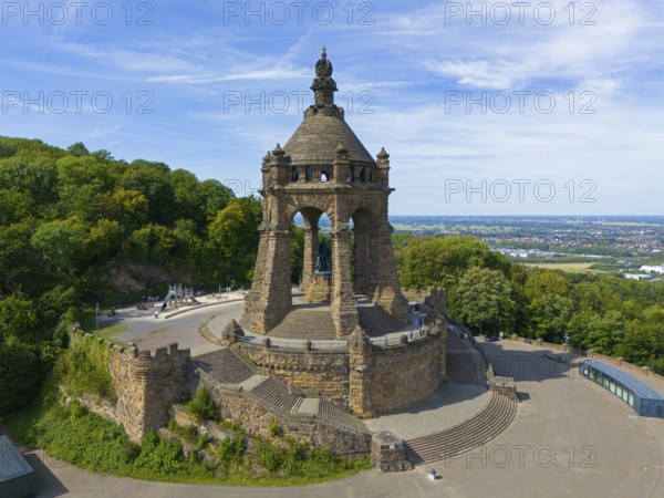 A monumental building on a hill, surrounded by trees and a sweeping view, aerial view, Kaiser
