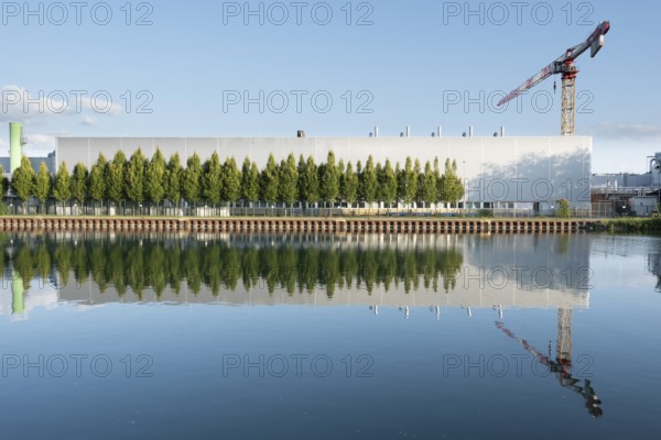 View across the Mittelland Canal to an industrial building with a crane, Garbsen, Hanover, Lower
