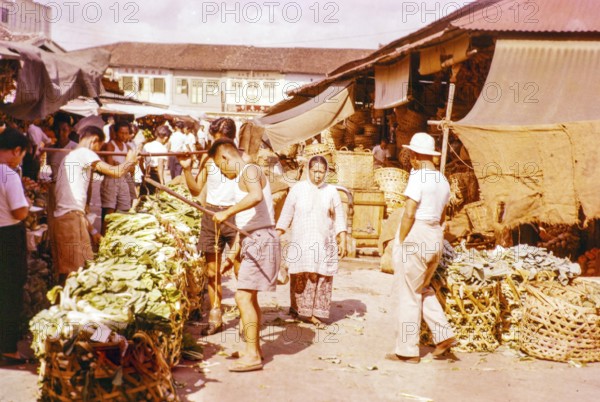 Porters with vegetables people shopping at the old market, Johor Bahru, Johor, Malaya, Malaysia,