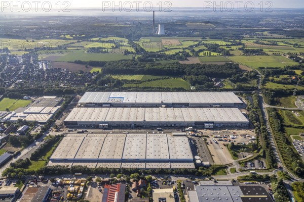 Large area with warehouses in the middle of a rural landscape under a sunny sky, aerial view Werl