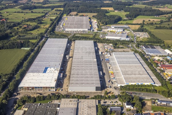 Spacious industrial complex with several large buildings and surrounding fields, aerial view Werl